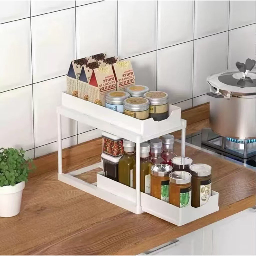 BLACK Two-tier pull-out storage rack. An organizational lifesaver for under the kitchen sink. Features adjustable shelves for easy storage of bottles and jars. In a sleek, modern design. Perfect as a kitchen shelf, bathroom organizer, or household storage