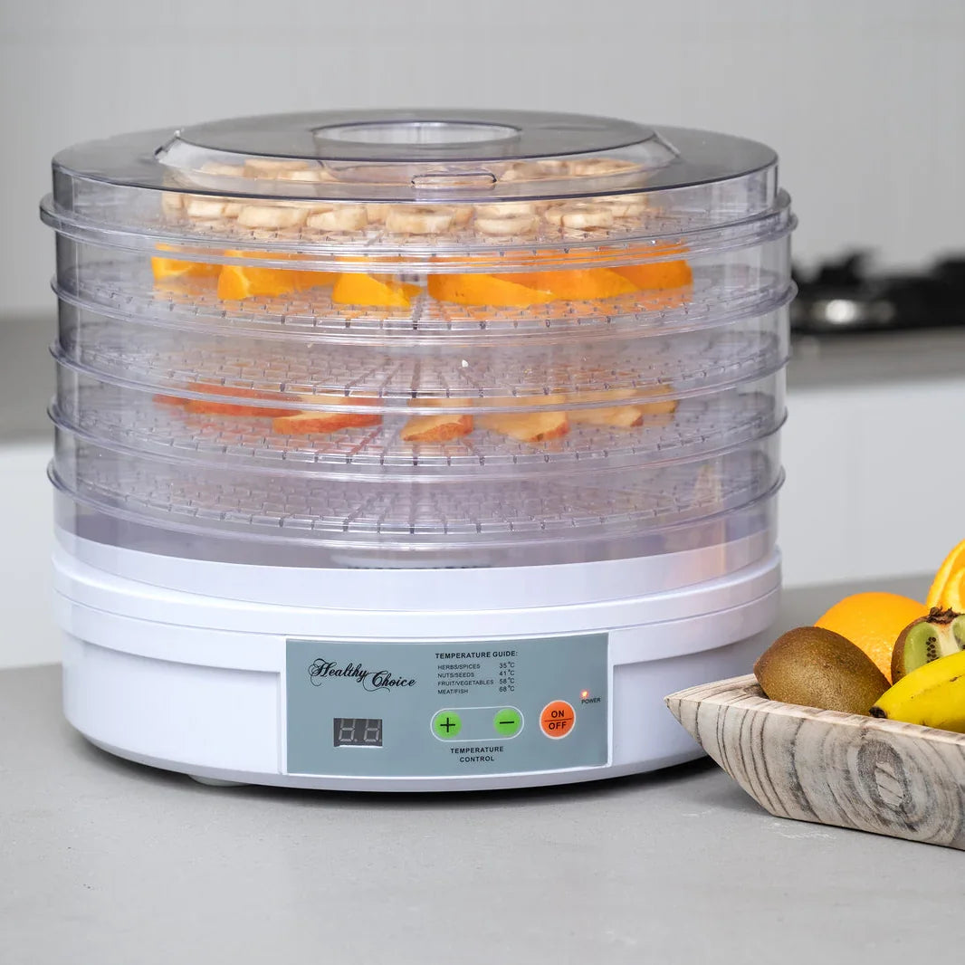 Food dehydrator with fruits on a kitchen counter