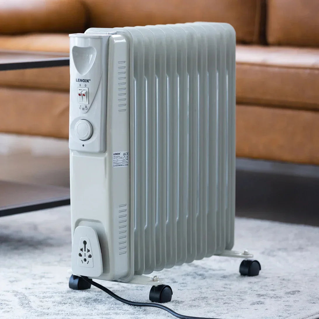 Portable electric heater in a living room setting with a couch and coffee table.