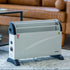 Convection heater on a carpeted floor with a brown leather sofa in the background