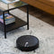 Robot vacuum cleaner on a rug in a living room setting