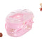 Pink pet carrier with transparent lid on a light wooden floor.