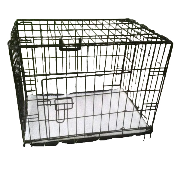 Black metal dog crate on grass