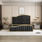 Black tufted bed with gold accents in a modern bedroom setting.