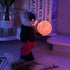 Holding the dreamy starry sky black top + red pants Creative Astronaut Bluetooth Speaker with 3D Starry Sky Lighting, Portable Wireless Moon Lamp Speaker - Perfect Gift for Space Enthusiasts