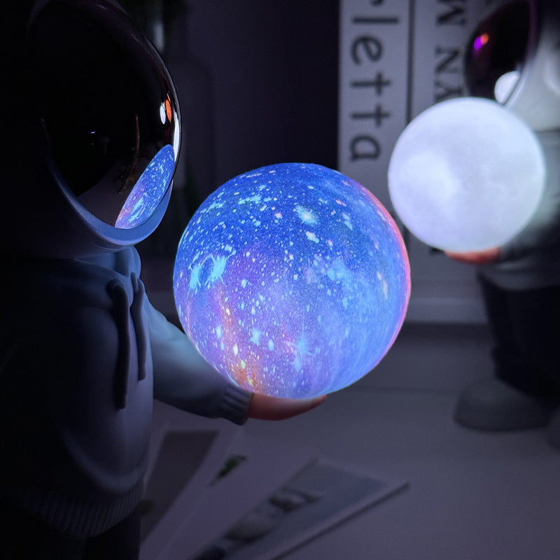 Holding the romantic moon grey top + navy blue pants Creative Astronaut Bluetooth Speaker with 3D Starry Sky Lighting, Portable Wireless Moon Lamp Speaker - Perfect Gift for Space Enthusiasts