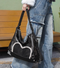 Stylish black tote backpack with heart embellishment - can be worn on one shoulder or as a backpack