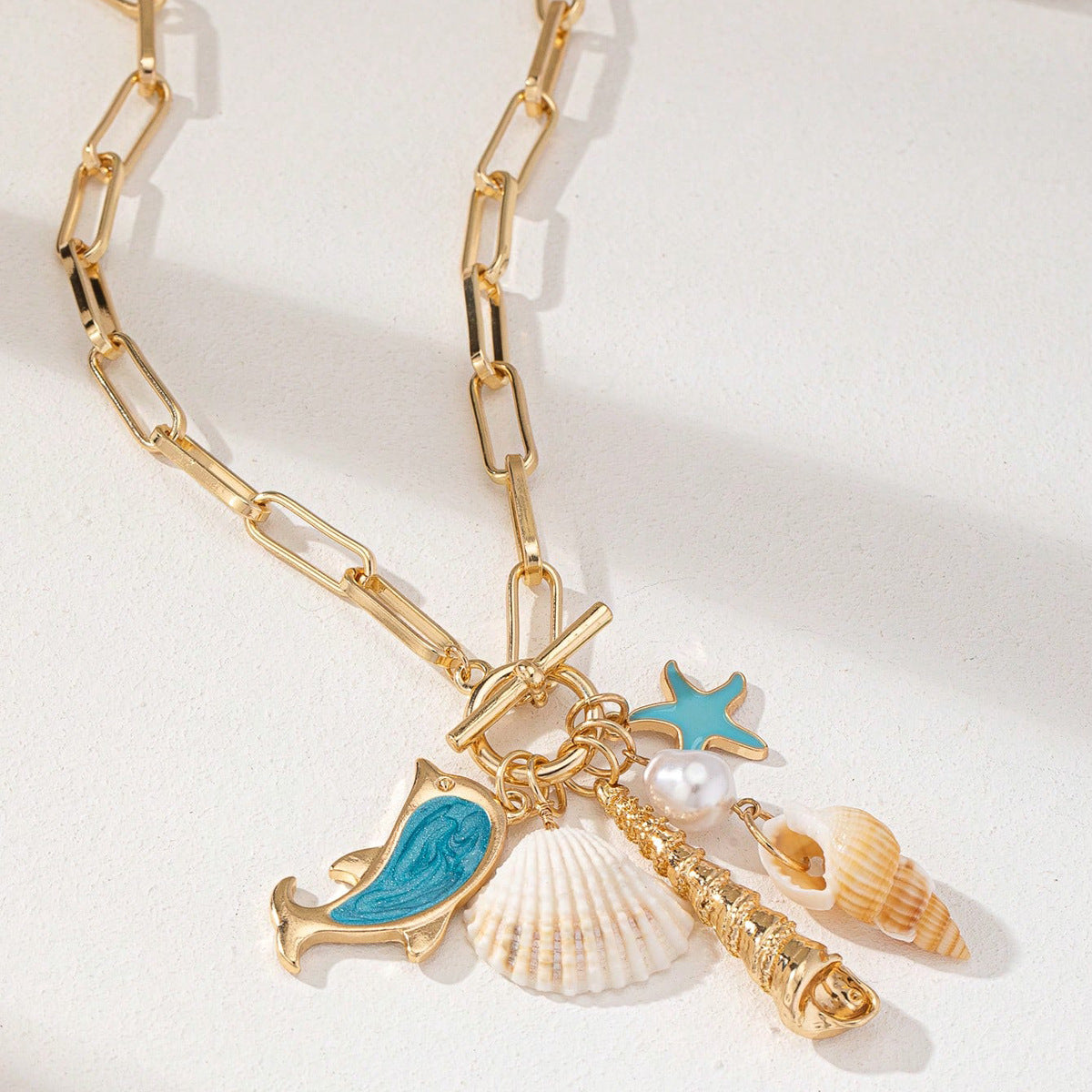 Gold Tone Paperclip Chain Toggle Necklace with Ocean Charms Dolphin Starfish and Seashell Pendant for Summer Beach Holiday
