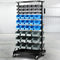 Mobile bin rack with multiple blue and grey storage bins in a warehouse setting